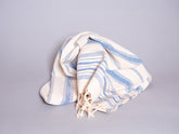 Hand loomed blue striped cotton towel.