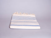 Hand loomed blue striped cotton towel.