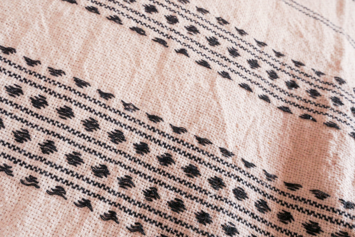 100% cotton, hand-woven cushion cover. Woven with threads in off-white, motifs in black. 