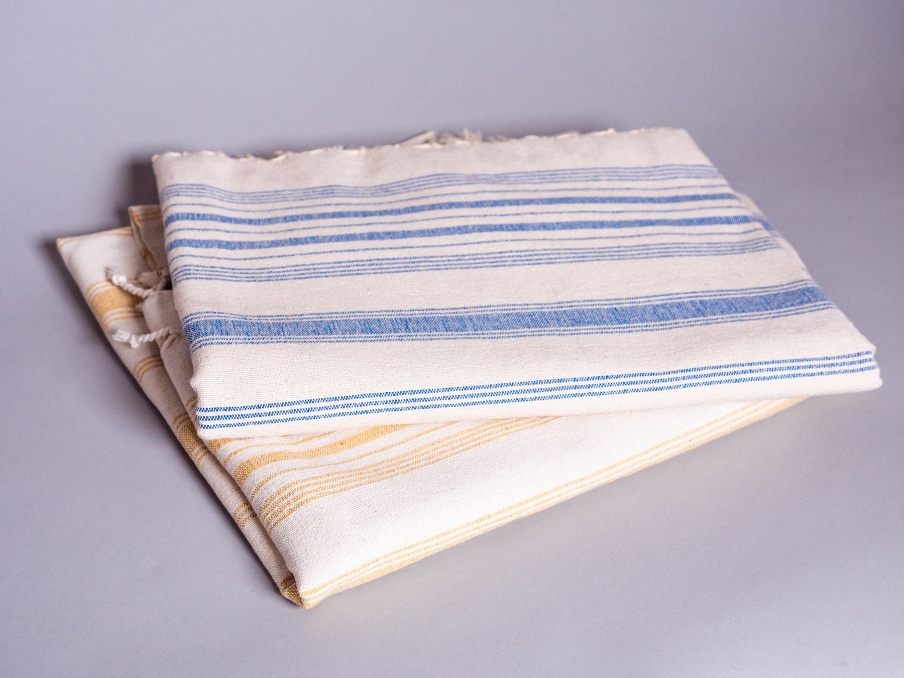 Hand loomed blue striped cotton towel.