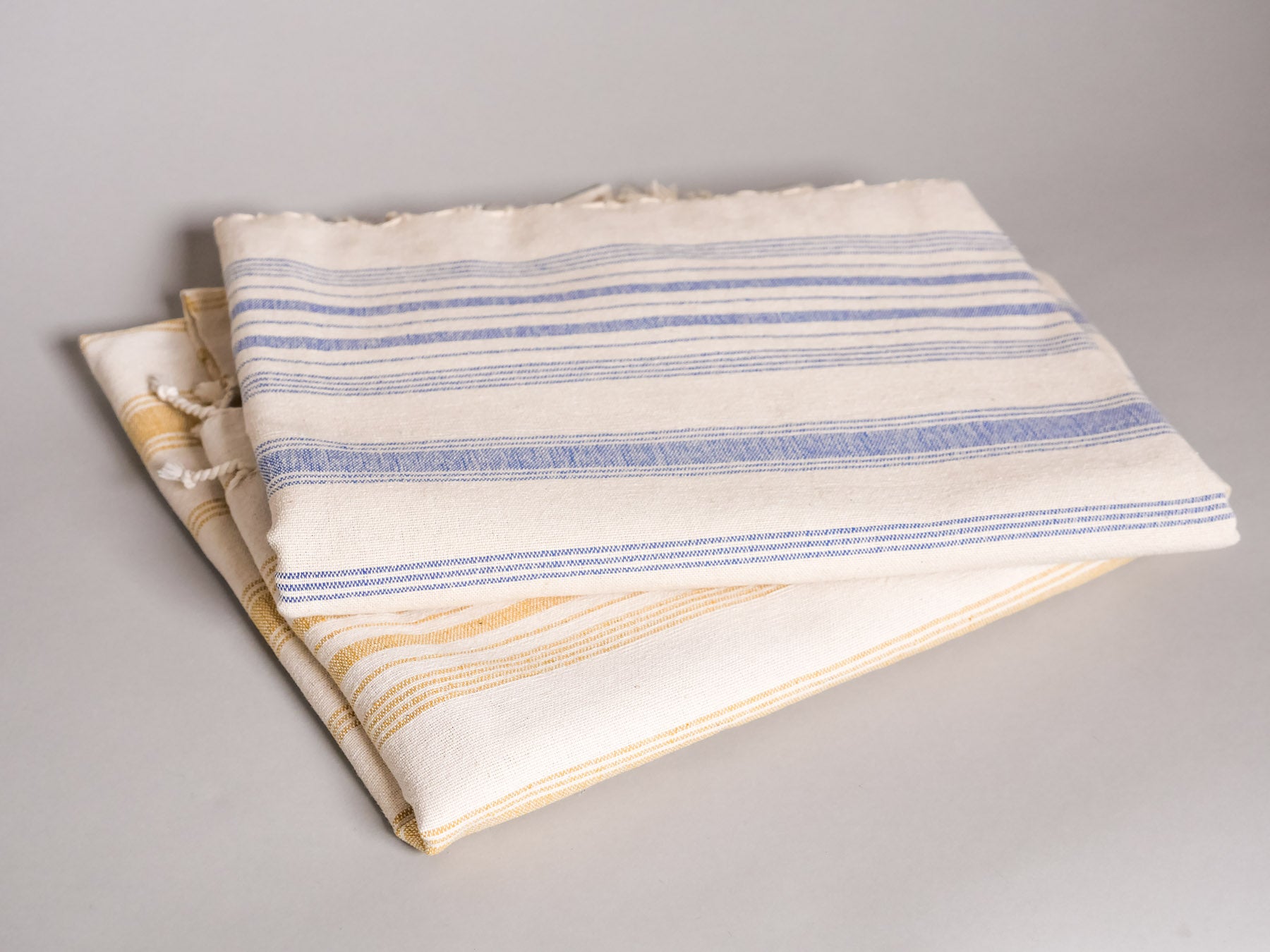 Pale yellow hand loomed towel.