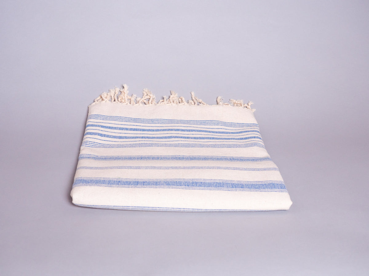 Hand loomed blue striped cotton towel.