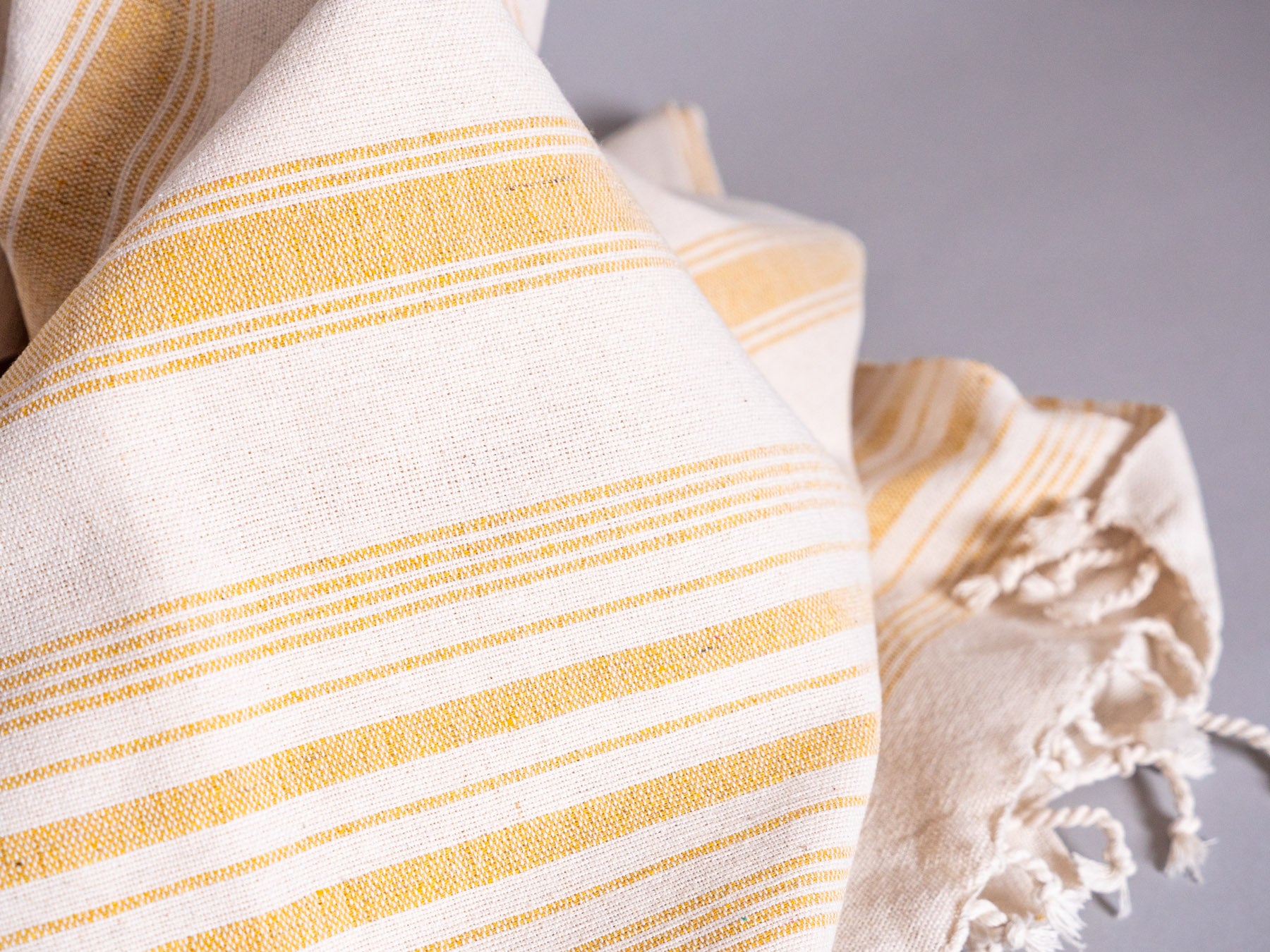 Pale yellow hand loomed towel.