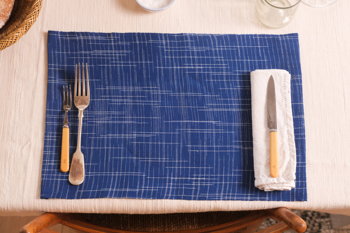  These graphic blue and white hand woven placemats are made using a traditional loom in Burkina Faso, using the highest quality locally produced cotton. The fabric is transformed into our Storie collection products in our Paris workshop.   Set of 2 placemats, 30x42cm, hand loomed cotton. Made in Paris, France.  