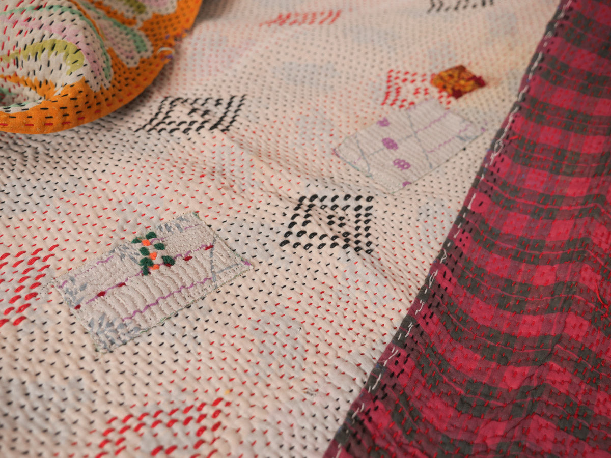 Patching on a vintage Kantha quilt. Cotton throw made from repurposed cotton saris,
