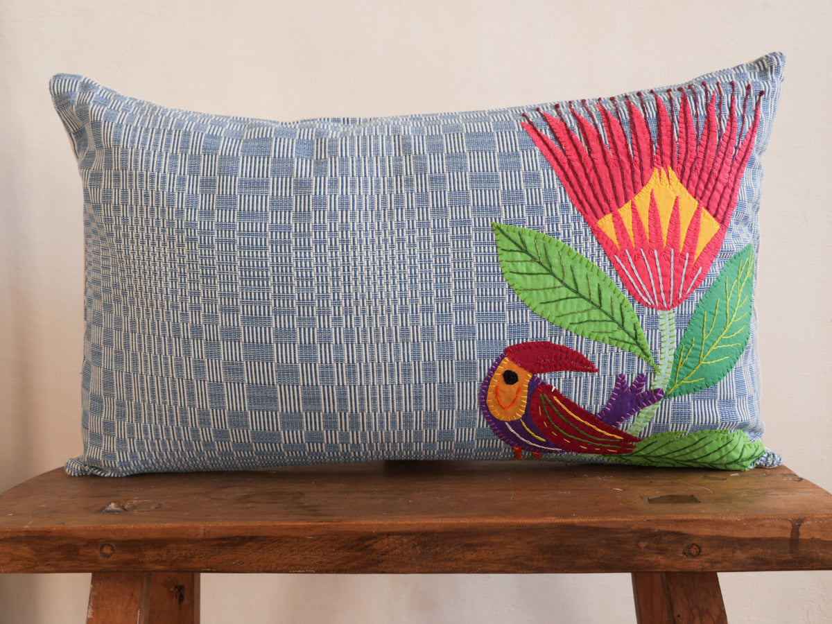 This cushion is a one of a kind piece, a collaboration between skilled artisans in the Philippines and South Africa. Embroidered hand loomed cotton on the front, and linen on the back