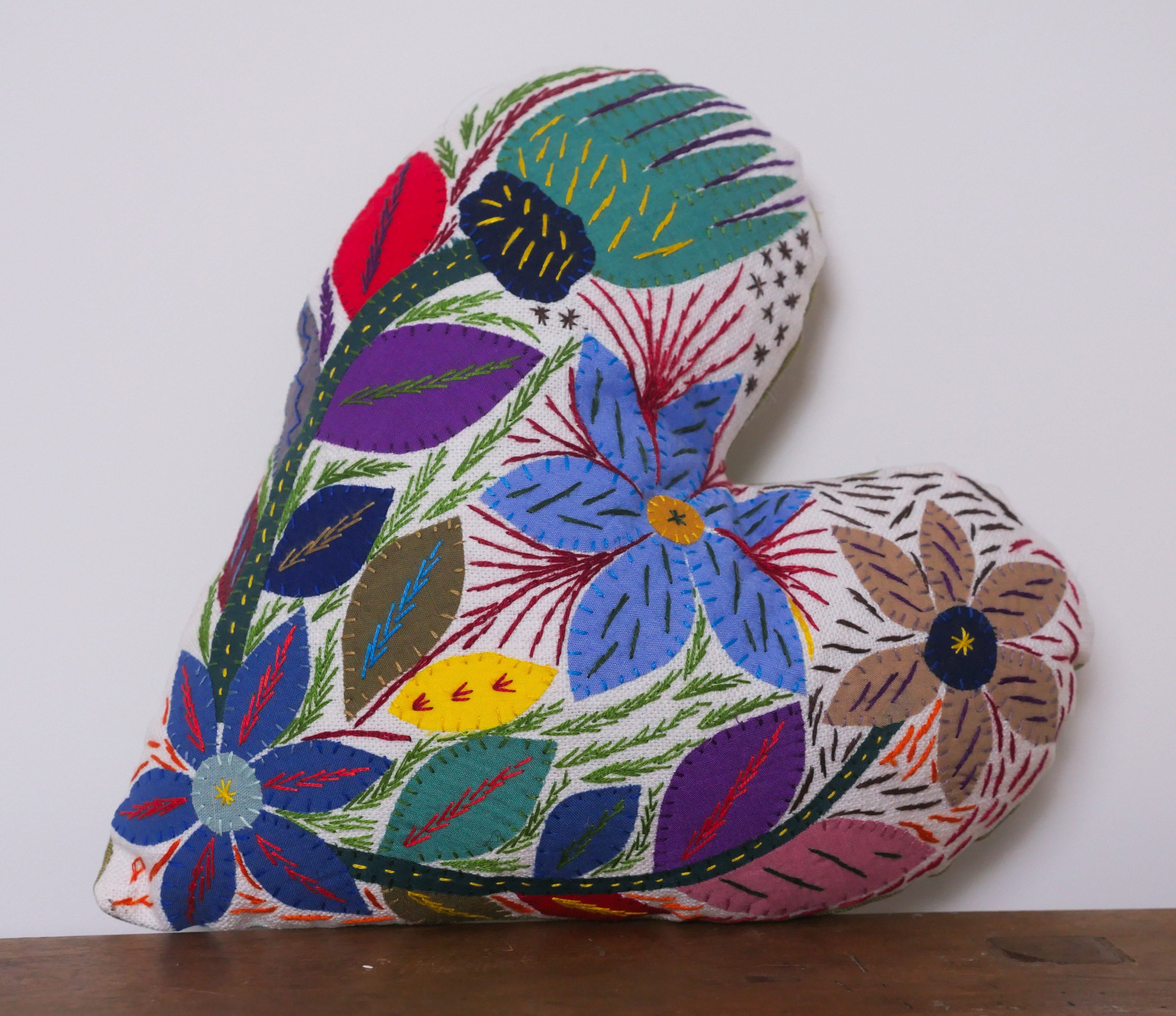 Hand embroidered heart shaped cushion