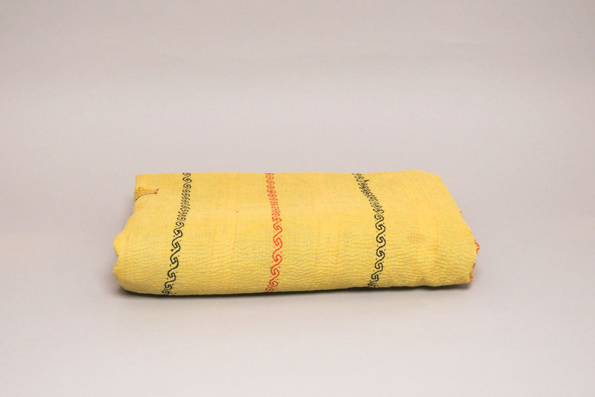 Vintage Kantha Quilt, a cotton throw made from repurposed cotton saris that have been layered and hand-stitched using the traditional Kantha technique.