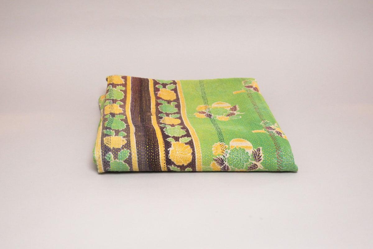 Vintage Kantha Quilt, a cotton throw made from repurposed cotton saris that have been layered and hand-stitched using the traditional Kantha technique.
