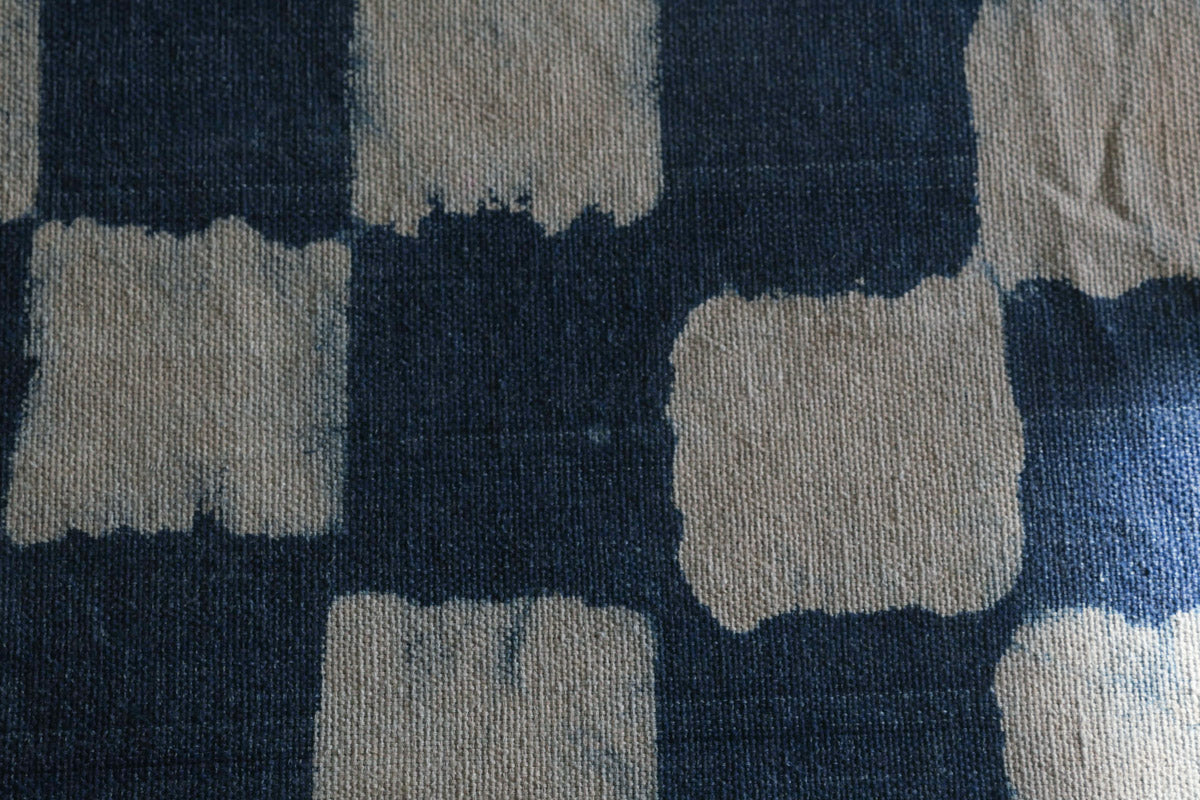 Thick hand loomed cotton cloth, dyed with natural indigo chequers in a rustic style. Can be used as a throw, or as a table cloth. Each piece is hand made so there will be small irregularities. Made by a community of weavers close to Jaipur in India.