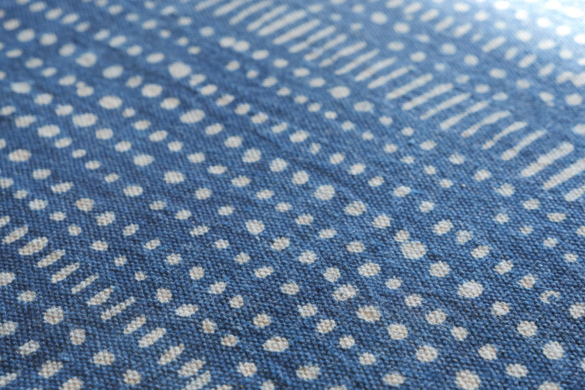 Thick hand loomed cotton cloth, dyed with natural indigo in a rustic style, dots and line motifs. Can be used as a throw, or as a table cloth. Each piece is hand made so there will be small irregularities. Made by a community of weavers close to Jaipur in India.
